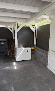 Home battery installed under a covered carport
