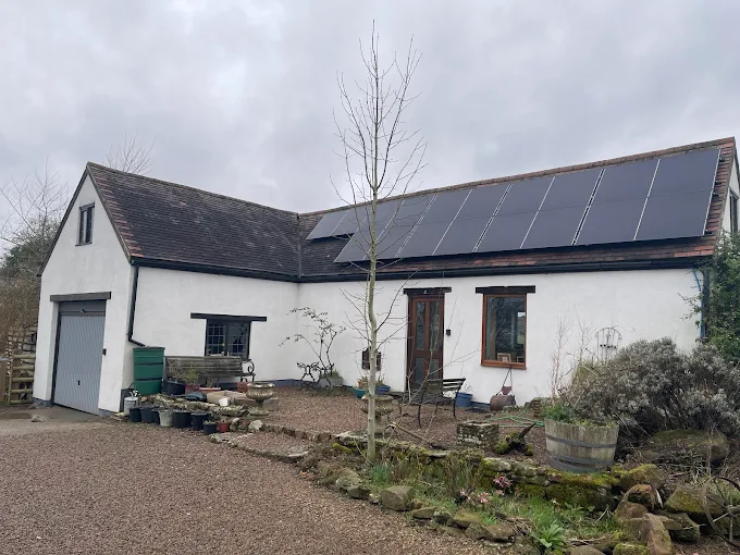 Whitewashed home with a long row of black solar panels in Co. Cork
