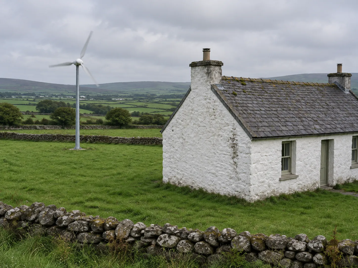 Free-standing domestic wind turbine beside an Irish cottage